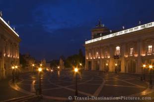 As dusk falls on Piazza Veneto in the city of Rome, Italy the lights give off a subtle glow which highlights the statues and historic buildings of the square.