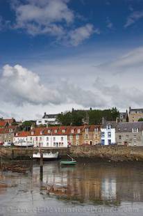 Boats are left high and dry in the harbour of St Monans during low tide in the Forth of Fife in Scotland.